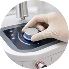 Hand placing a card into a card reader or scanner