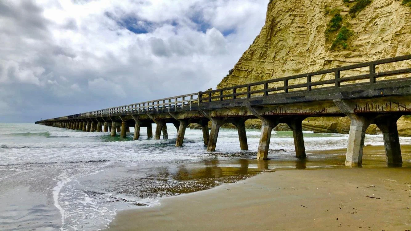 A boardwalk extending into the ocean as far as the eye can see