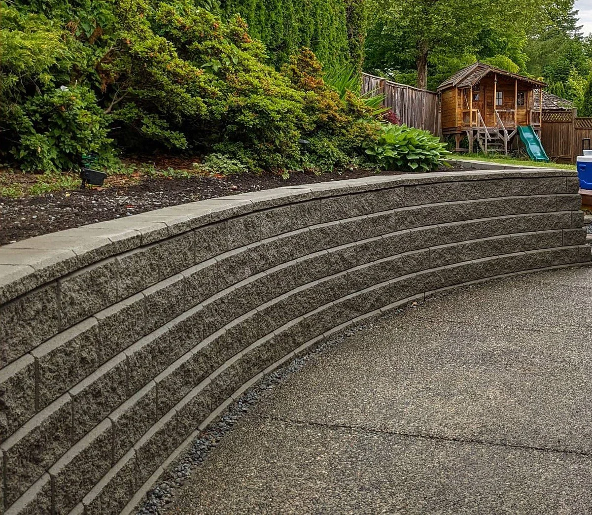 Curved Allan Block retaining wall - Coquitlam backyard