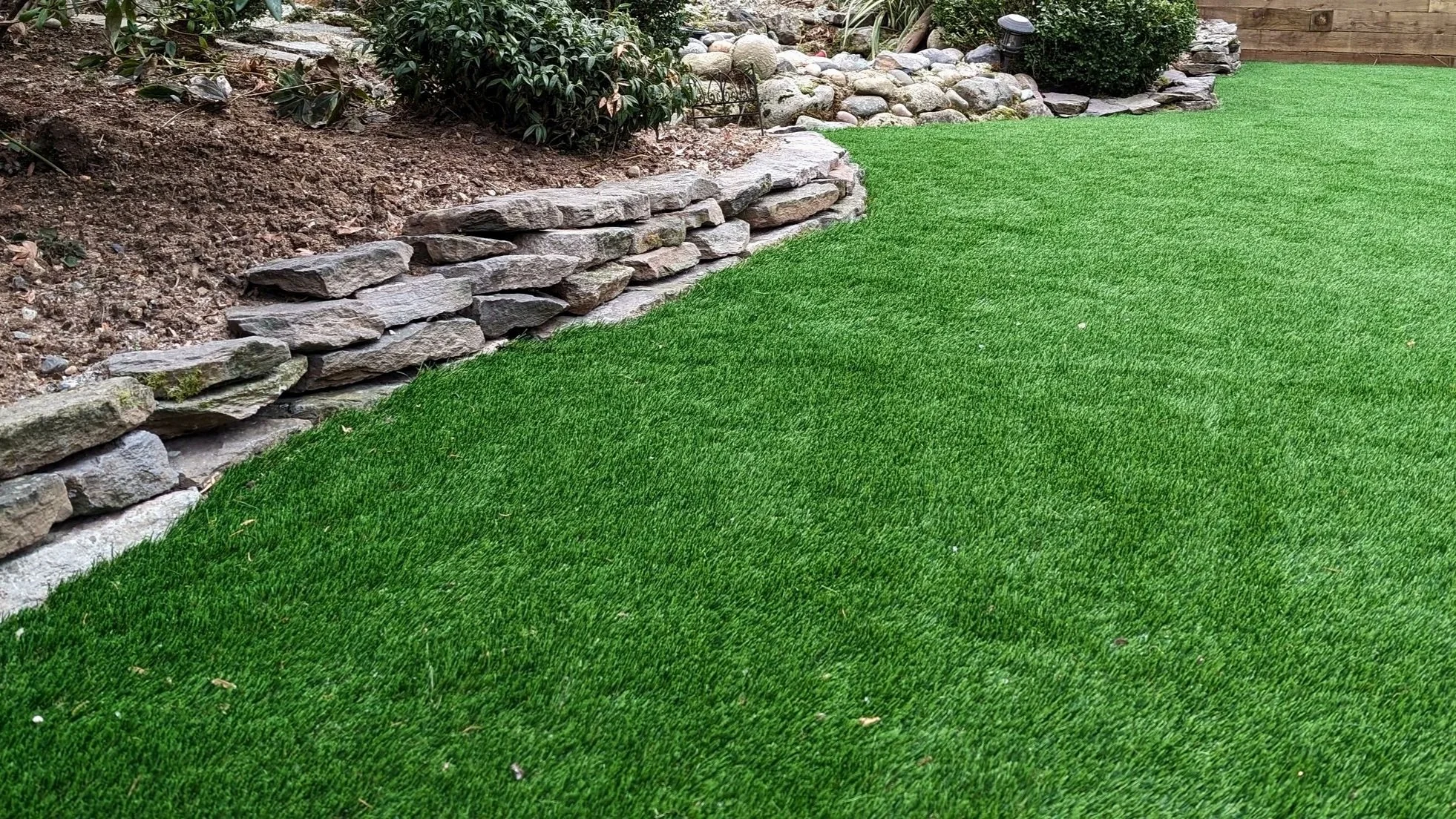 Artificial turf, natural stone wall - Burnaby