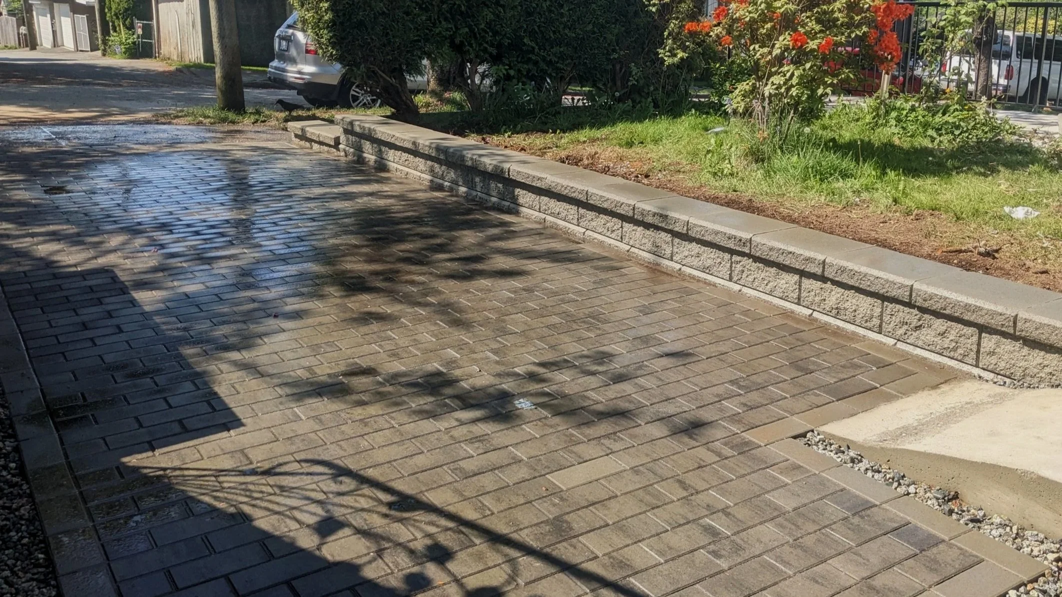 Interlocking paver driveway with low retaining wall - Vancouver