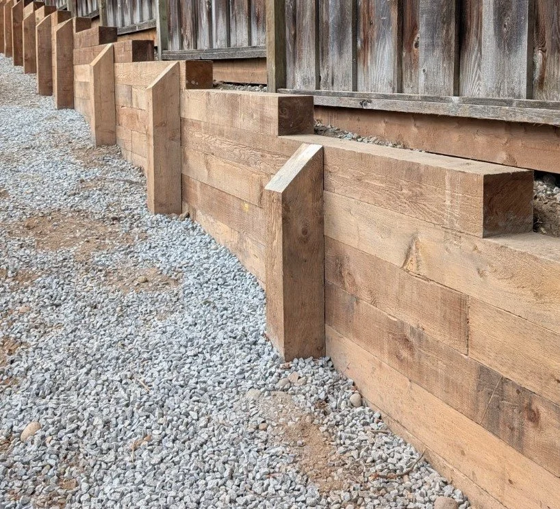 6x6 wooden retaining wall 7with support posts installed in front of the wall - Coquitlam