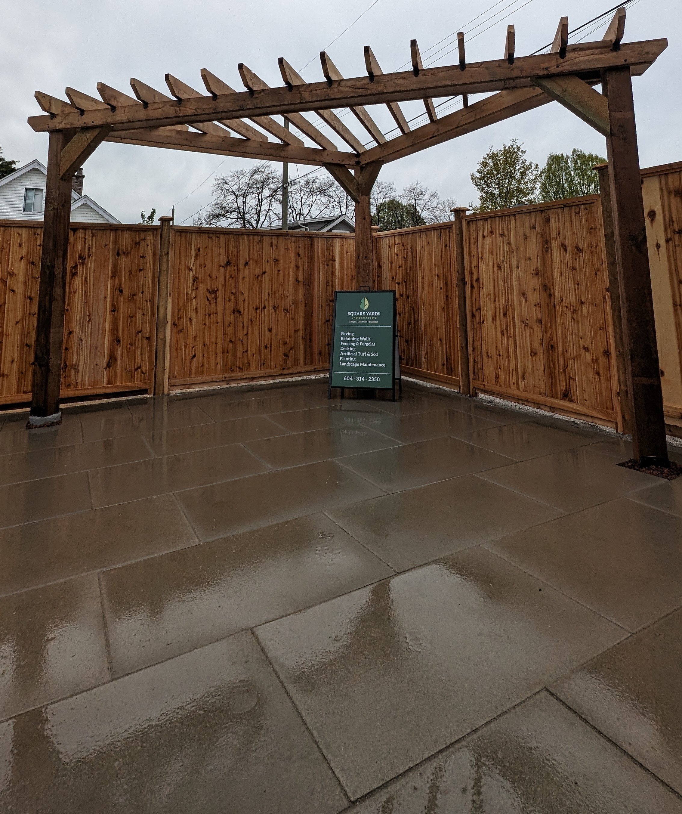 Cedar pergola over a paver patio