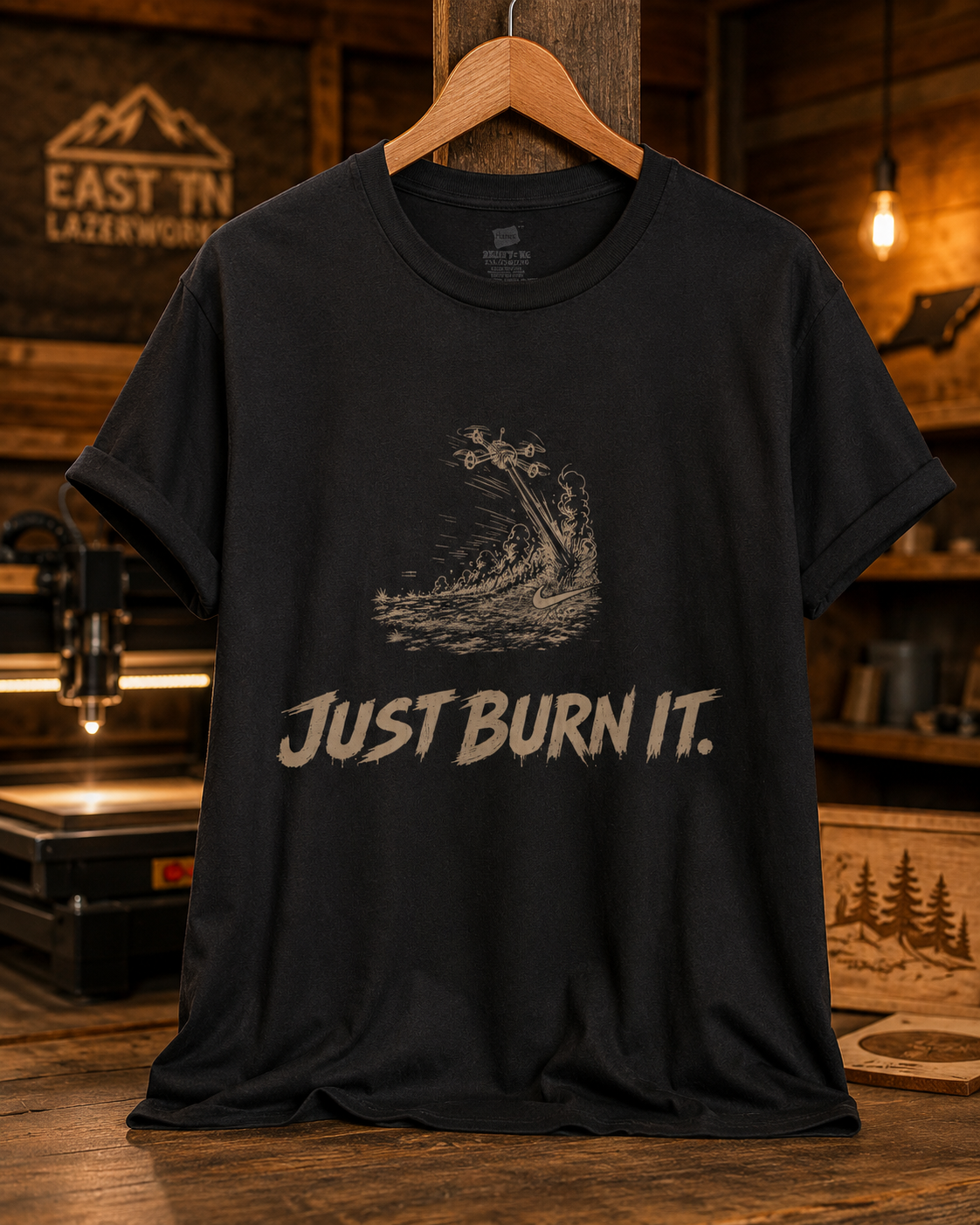 Black T-shirt with a graphic of a spaceship crashing into water, with smoke and fire, and the text "Just Burn It" at the bottom.