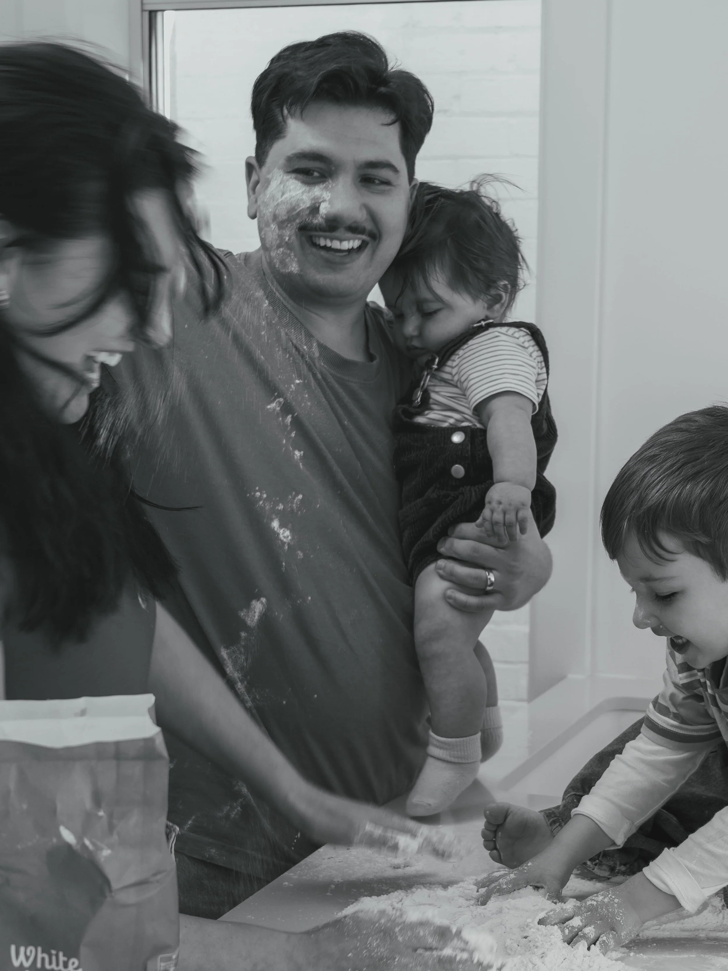 Family making pasta in a kitchen