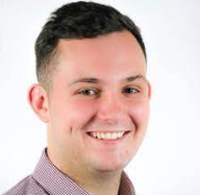 Portrait of a smiling man with short dark hair, wearing a collared shirt.