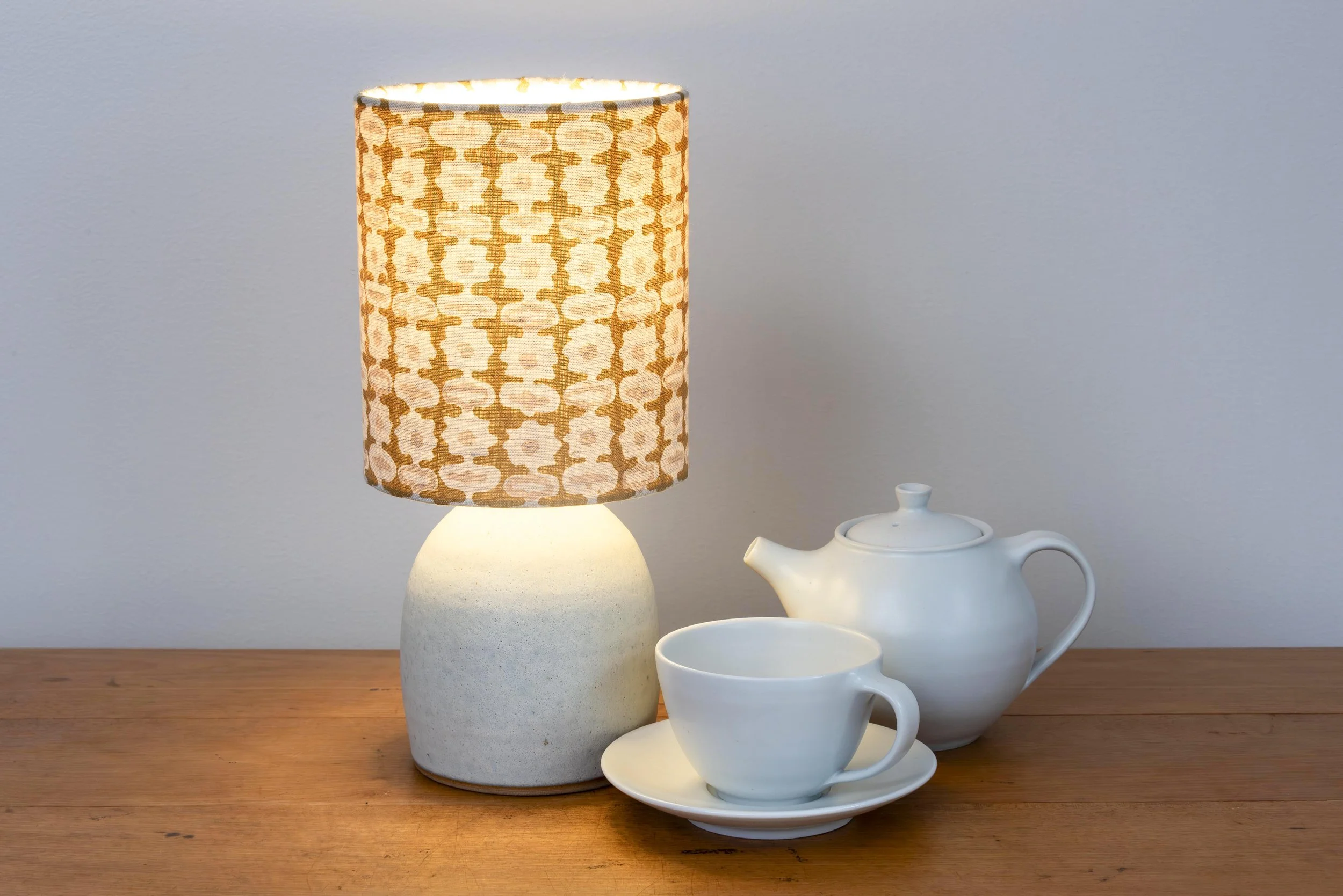 White matt stoneware lamp with handblocked linen shade