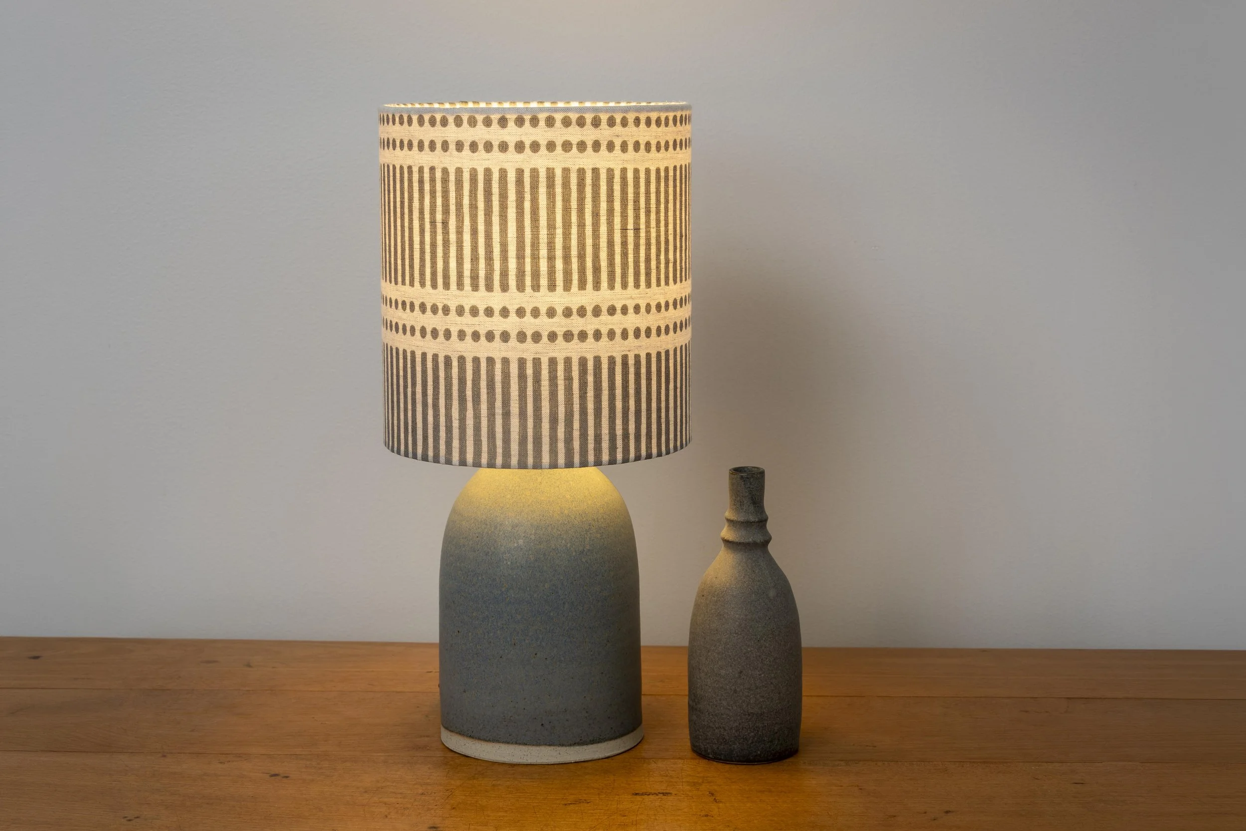 Matt slate blue glazed base with handblocked dots and dashes linen shade