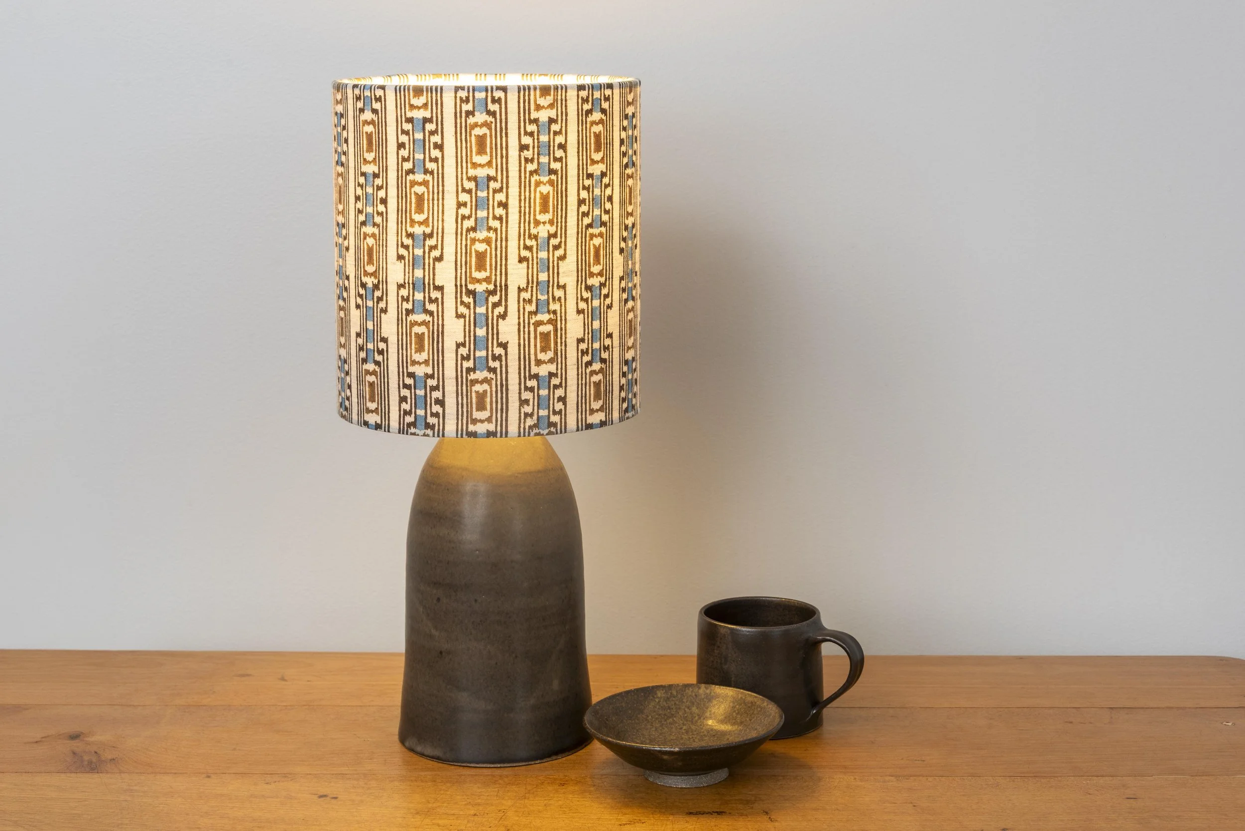 Matt chocolate-glazed base with hand blocked linen shade