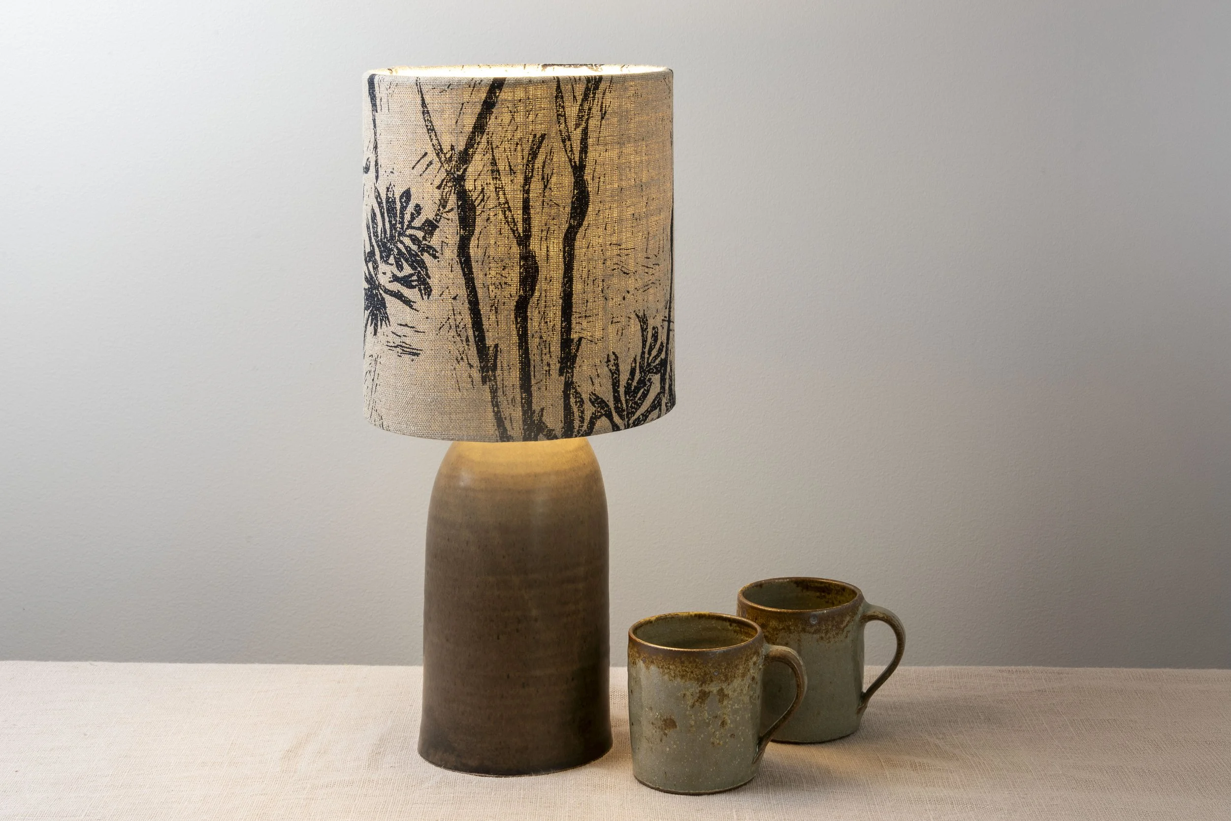 Matt chocolate glazed stoneware lamp with linen textured print shade