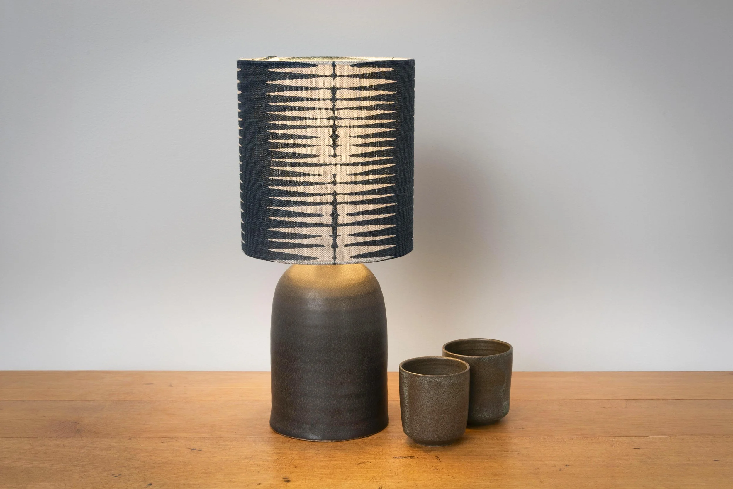 Charcoal matt stoneware lamp with handblocked linen shade