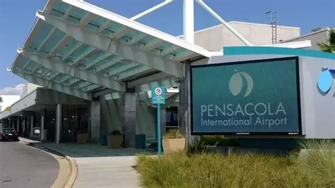 Entrance to Pensacola International Airport with a large sign and modern architecture.