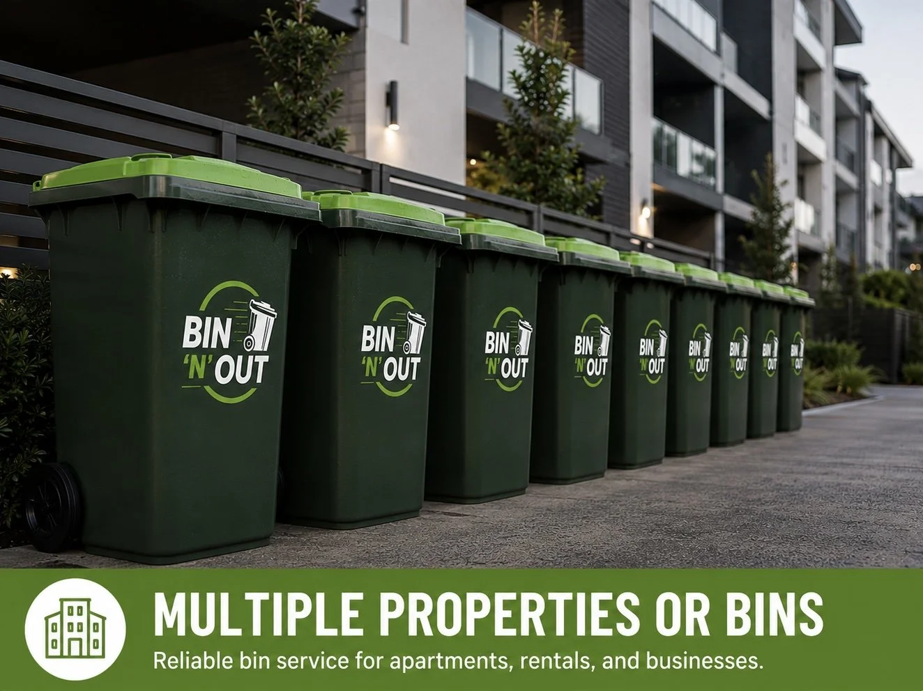 Multiple green trash bins lined up outside of an apartment building with a sign promoting reliable bin services for apartments, rentals, businesses, holiday homes, retirement villages and housing complexes.
