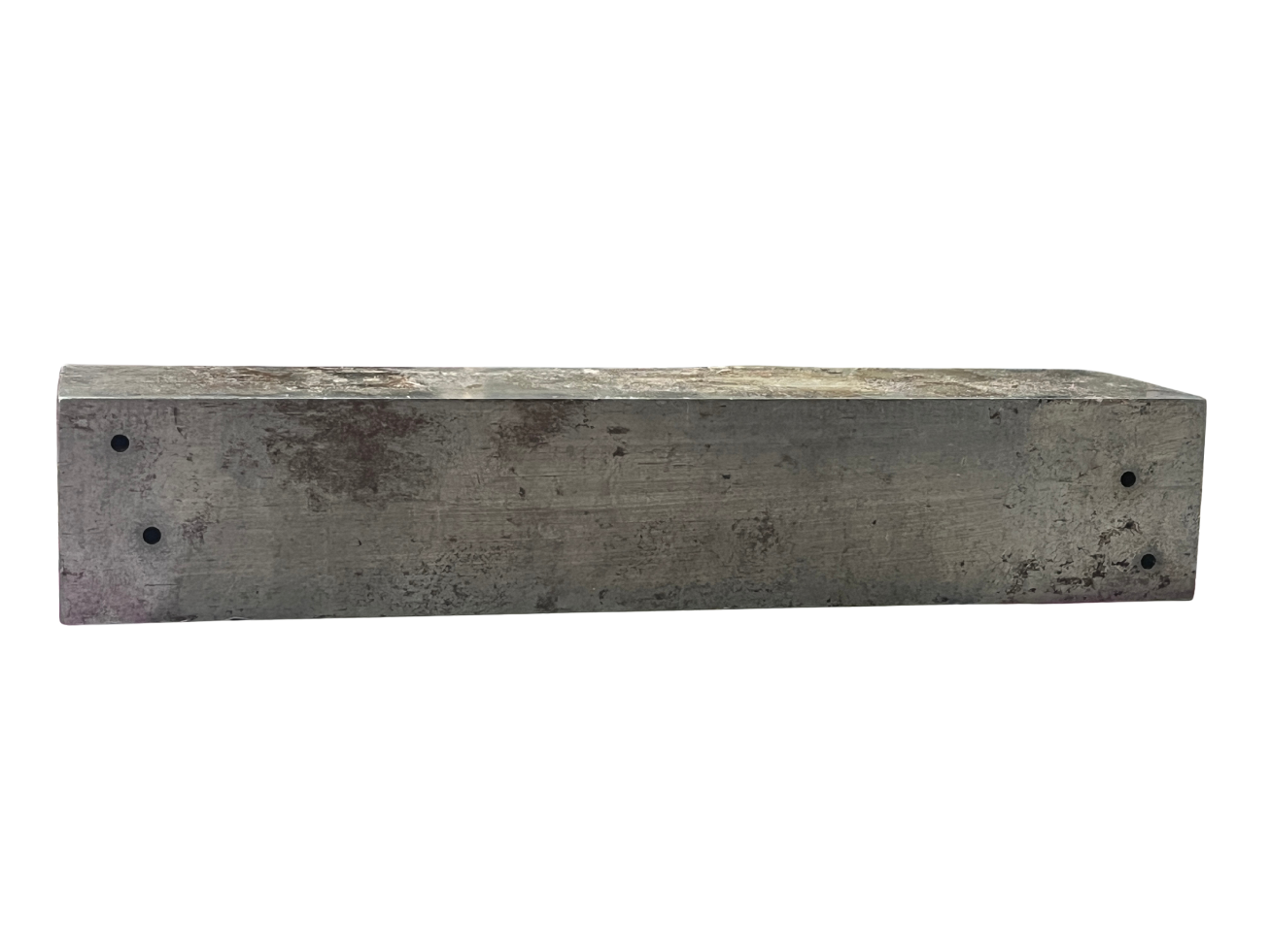 A long rectangular piece of wood or metal with a rough, weathered surface and four small holes, set against a plain white background.