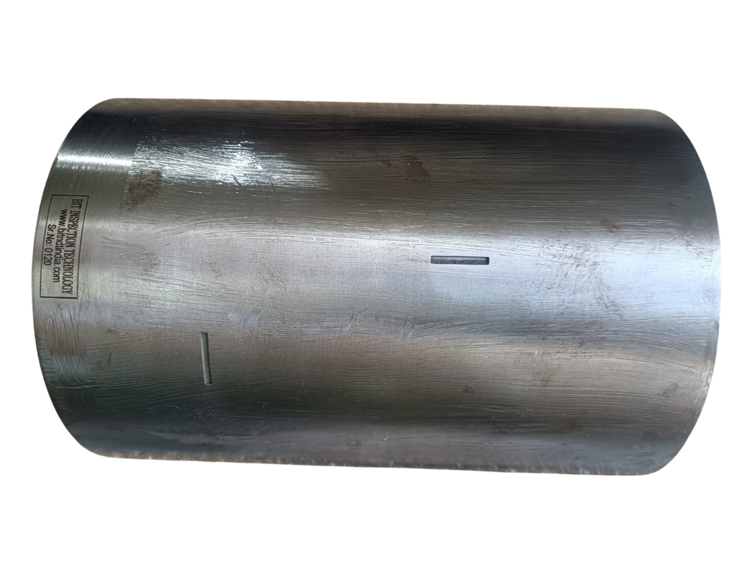 A cylindrical metal object with a brushed finish and a label attached on the side.