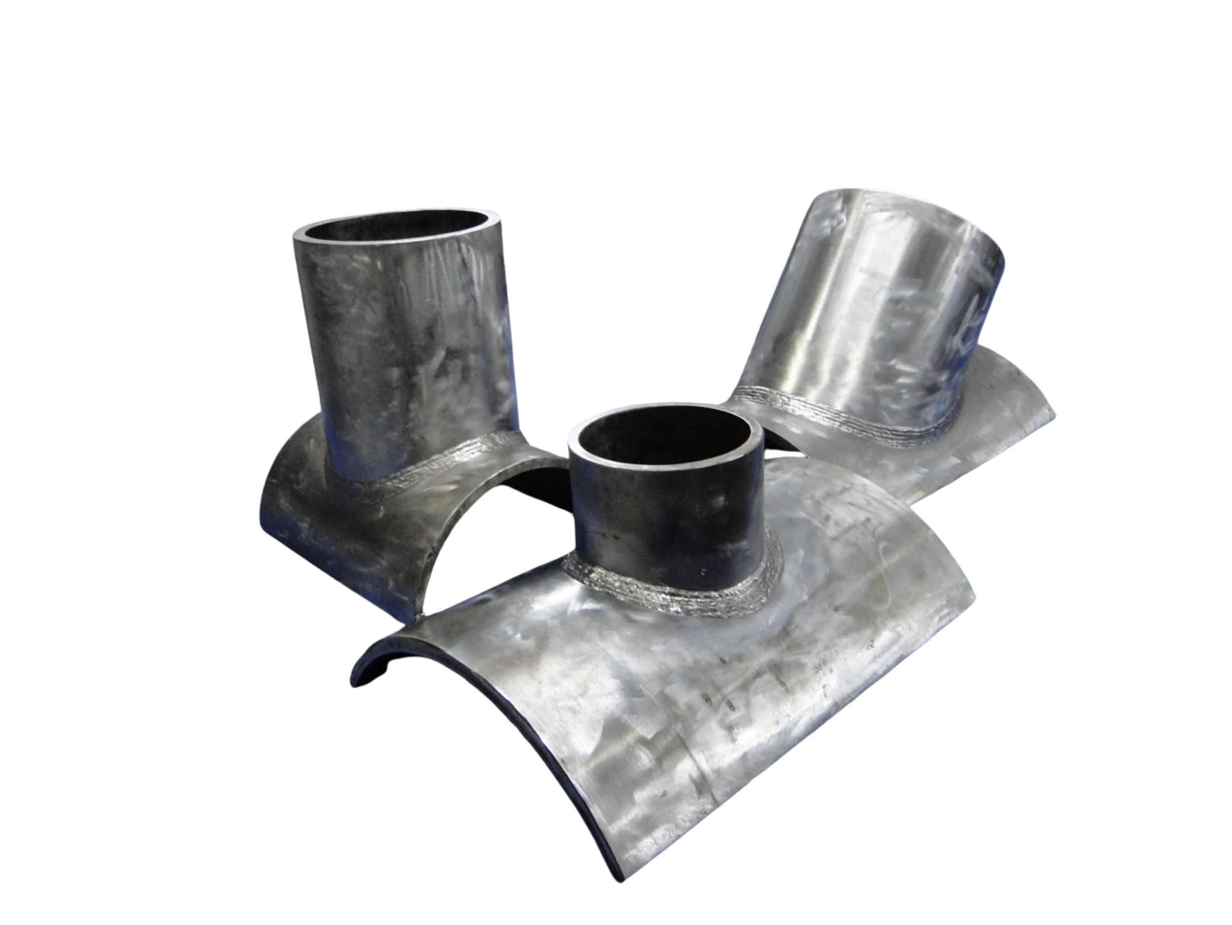 Close-up of metal pipes with welded joints on a flat surface.