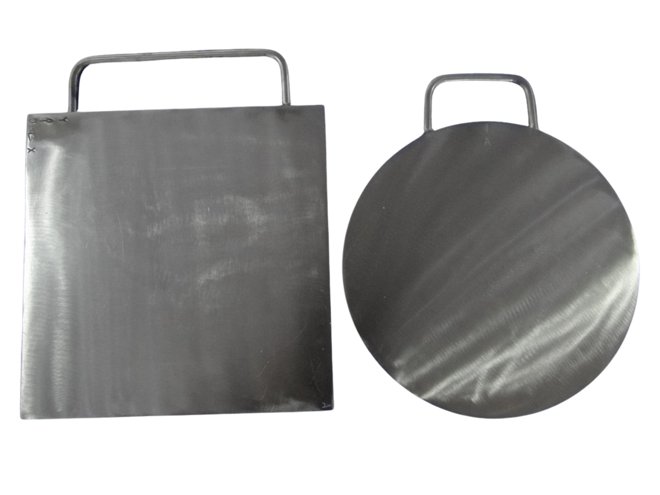Close-up of two metallic kitchen tools: a rectangular griddle and a round griddle, both with handles.