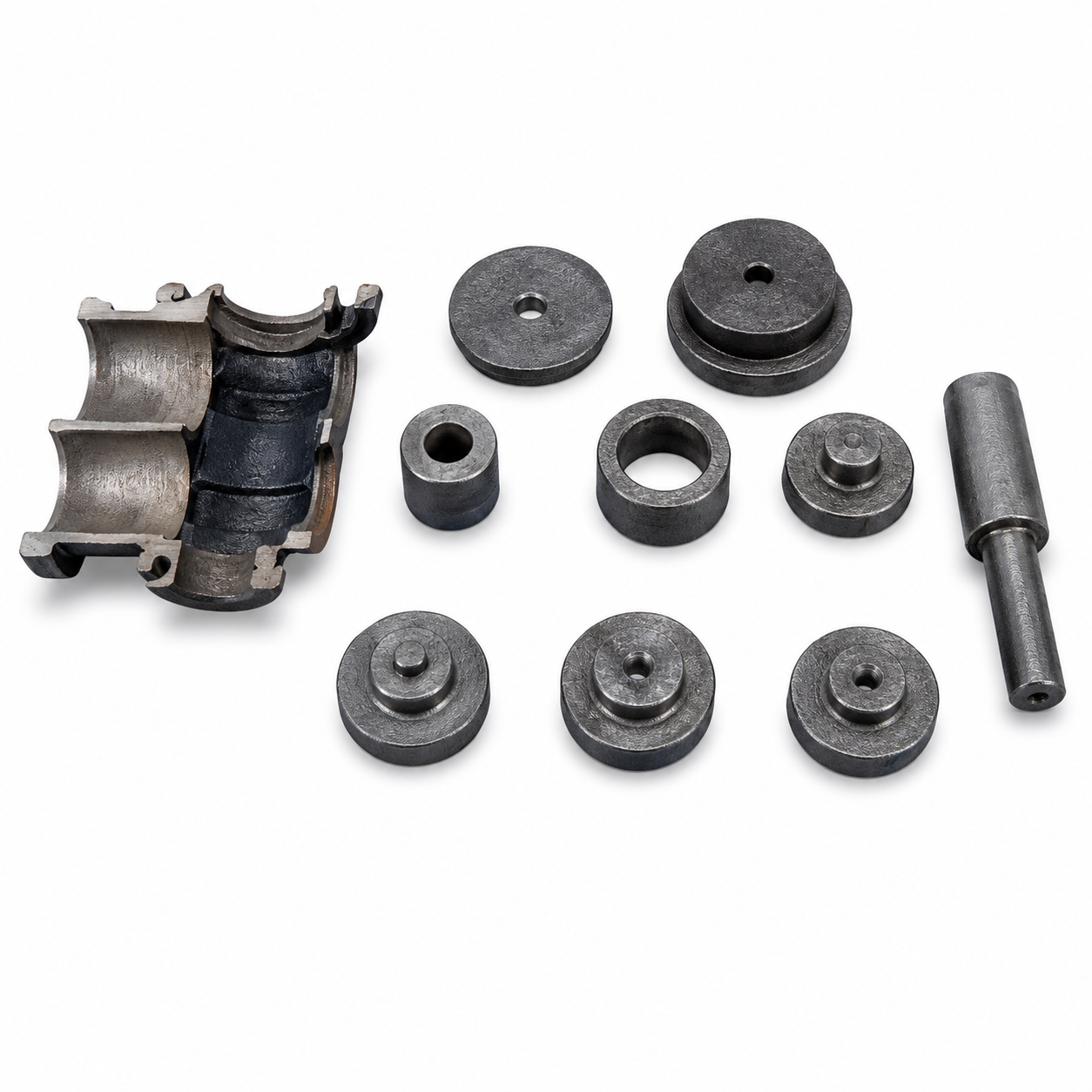 Set of metal mechanical parts including circular weights, a cylindrical spacer, and a hollow housing, arranged on a white background.