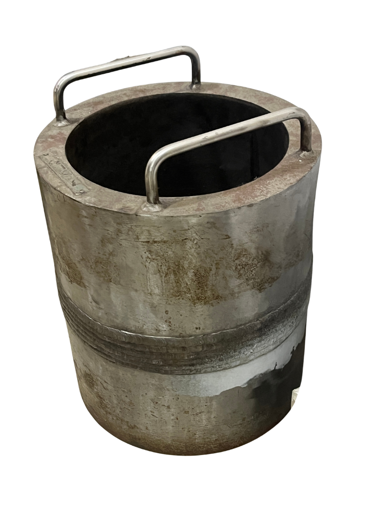 A large, circular, industrial metal tub with two metal handles on top, used for boiling or processing large quantities of something.
