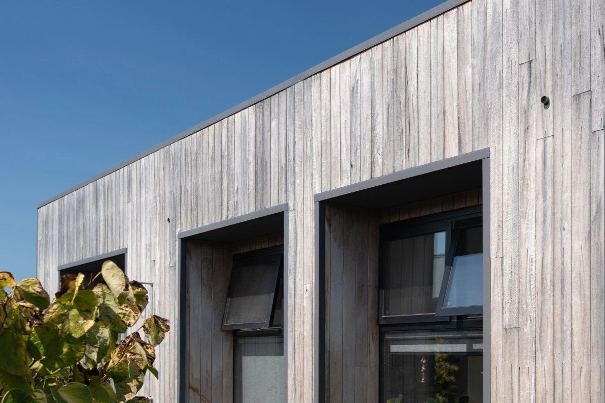 A contemporary barn-style home at Witchcliffe Ecovillage, designed for sustainable living and a close connection to the surrounding bushland. Passive solar design, efficient glazing, natural ventilation, and timber cladding create a warm, energy-effi