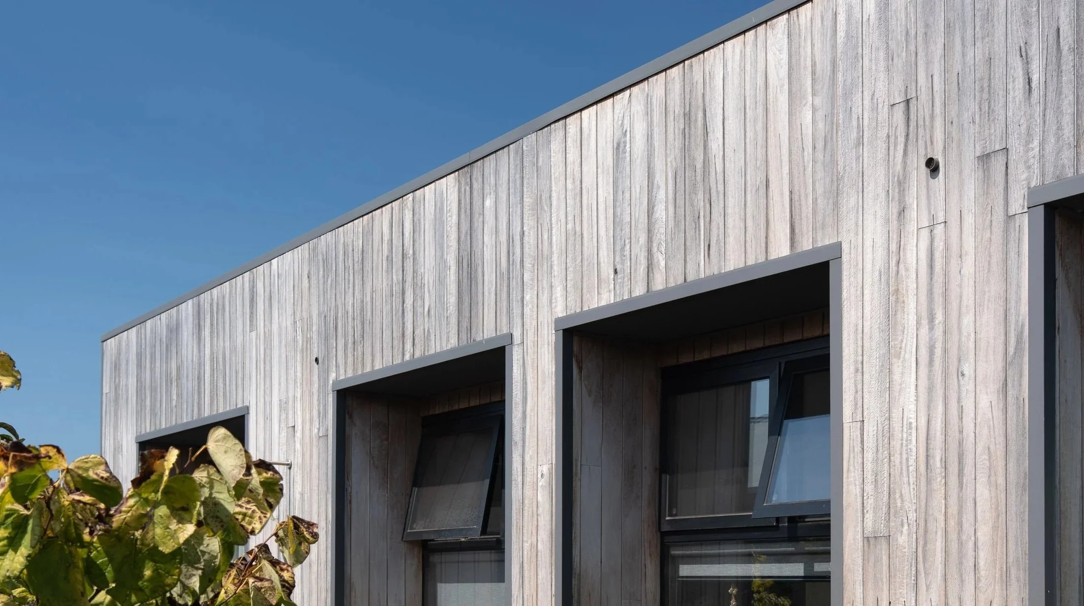 A contemporary barn-style home at Witchcliffe Ecovillage, designed for sustainable living and a close connection to the surrounding bushland. Passive solar design, efficient glazing, natural ventilation, and timber cladding create a warm, energy-effi