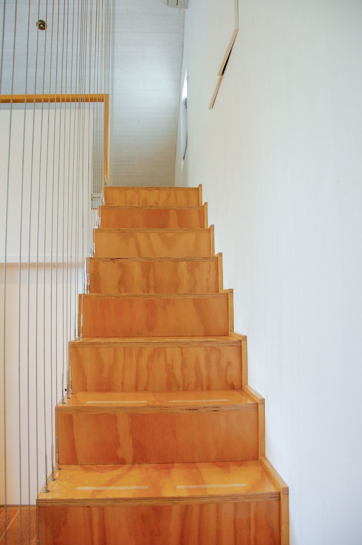 Timber staircase inside G.R.E.B. straw bale home in Hilton, Fremantle