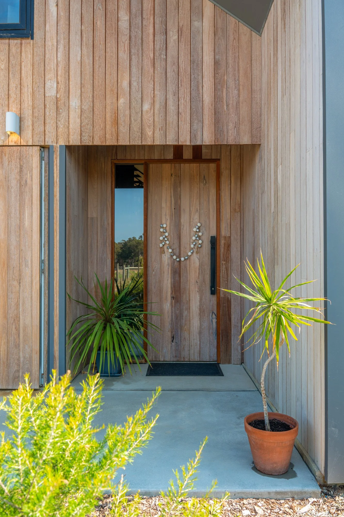 Timber-clad entry to sustainable Eco Barn House at Witchcliffe Ecovillage, Western Australia