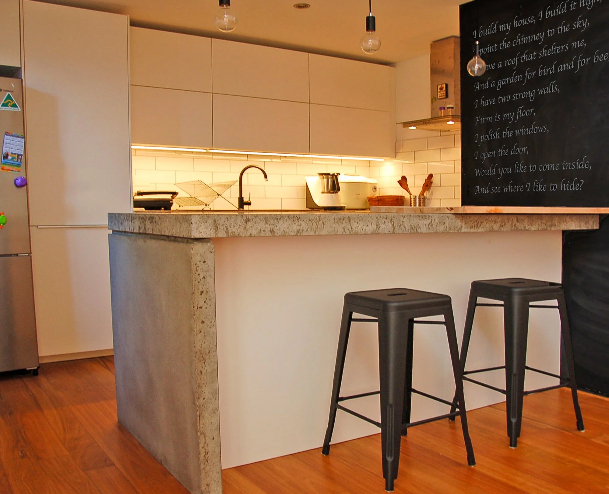 Contemporary kitchen in G.R.E.B. Strawbale House in Hilton with concrete benchtop and timber flooring