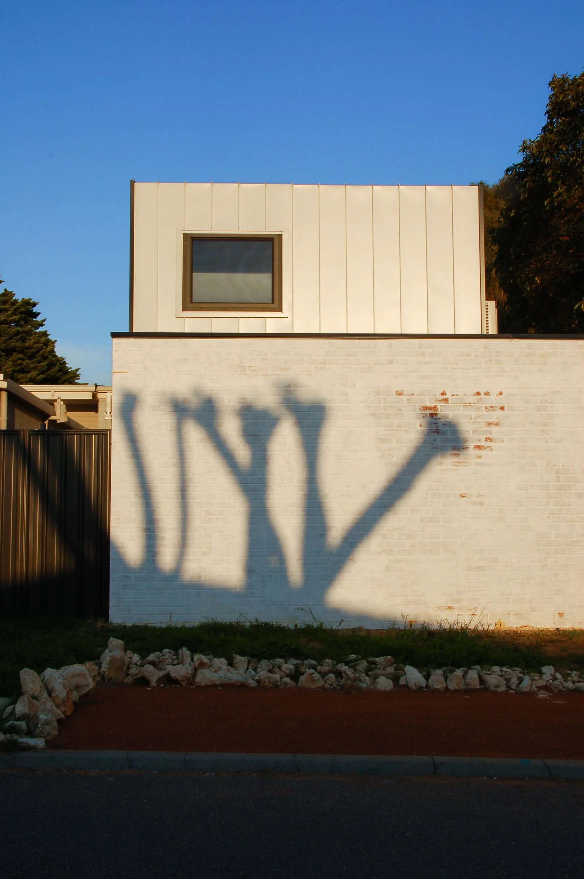Compact granny flat in Hamilton Hill with white brick lower level and metal-clad upper storey