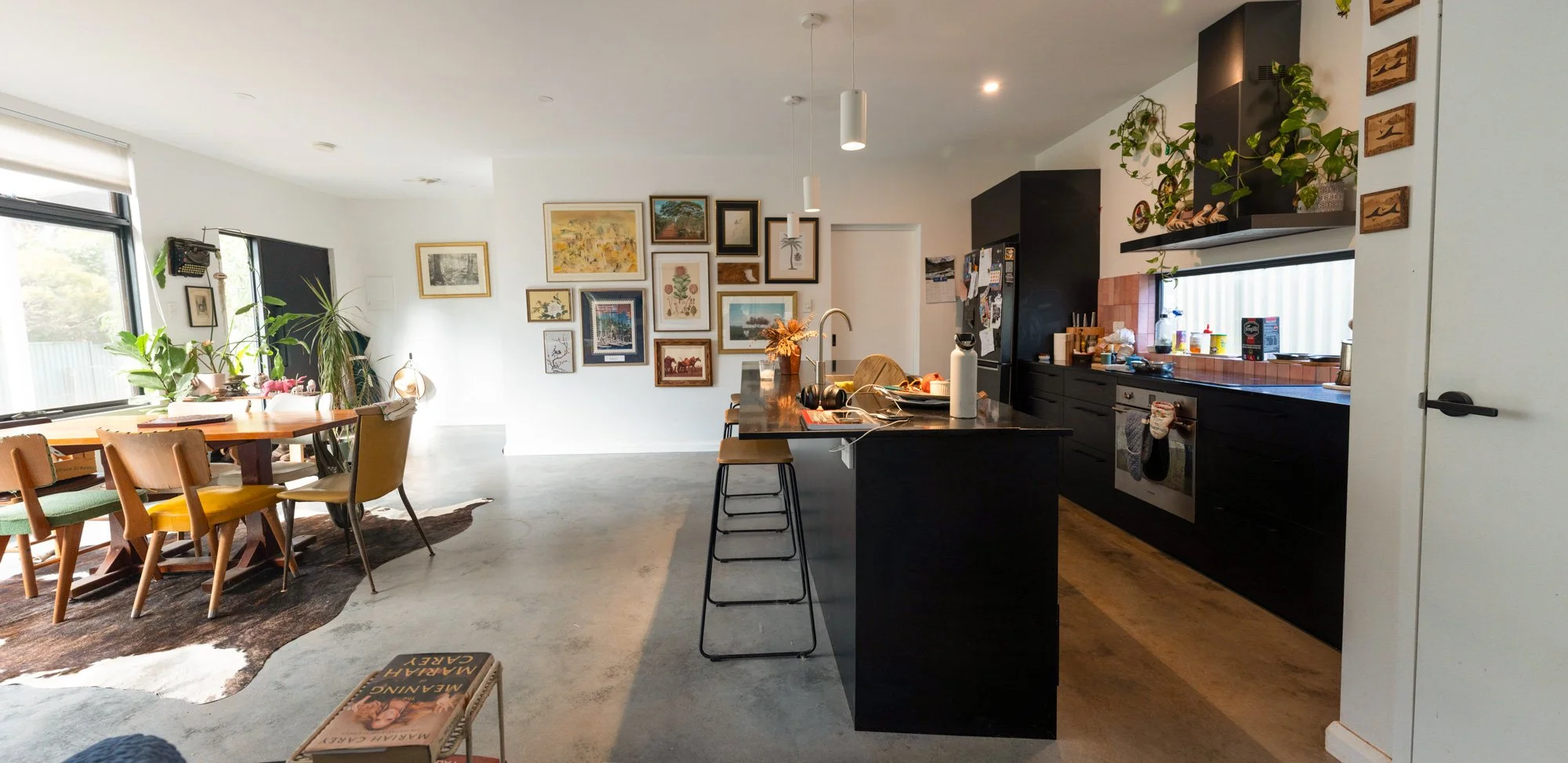 Open-plan kitchen and dining area in passive solar home in Hilton, Fremantle, with concrete thermal mass flooring