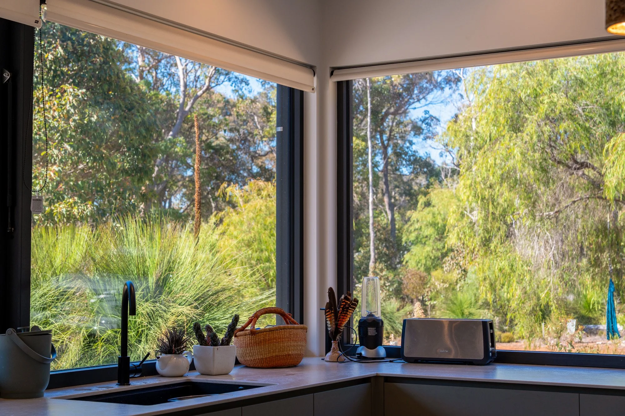 Kitchen windows overlooking native bushland in sustainable Margaret River forest home