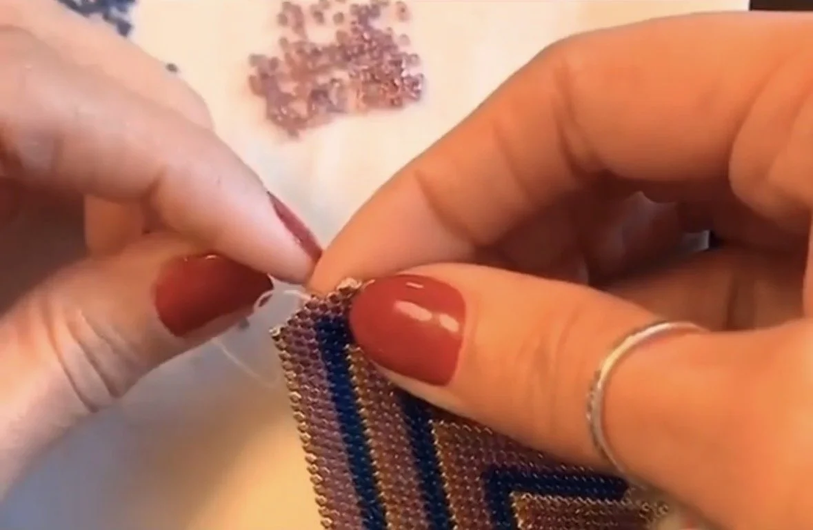 Close-up of Cheryl Shenandoah creating Native American and Haudenosaunee beadwork by hand.
