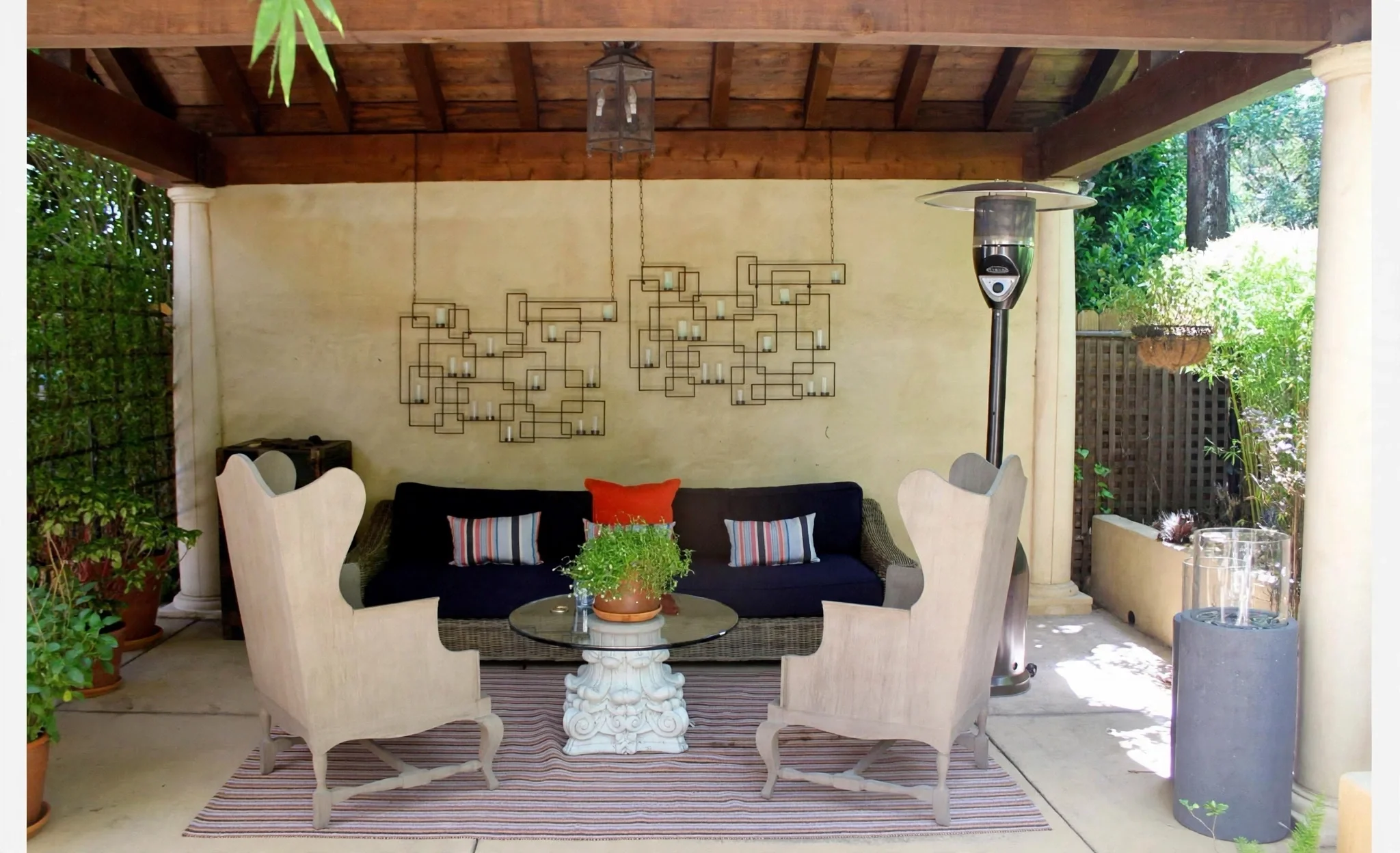 Covered outdoor lounge with sculptural seating and garden views at a West Hollywood residence