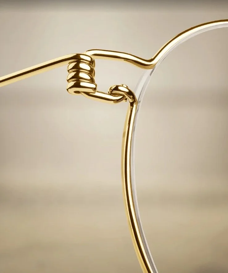 Close-up of a gold and silver wire sculpture with interlocking loops