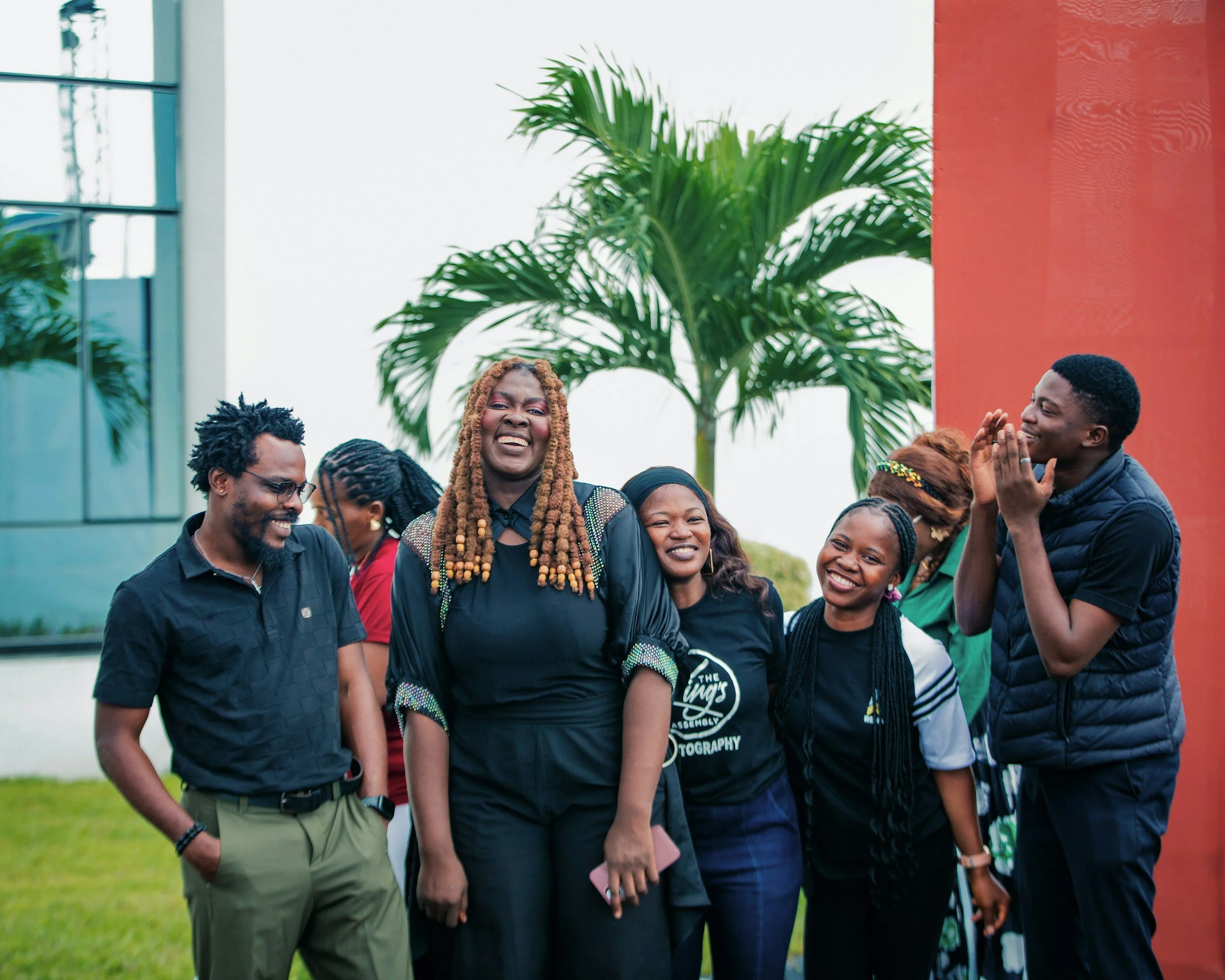 Group of black people standing, smiling, having conversations and engaging with eachother