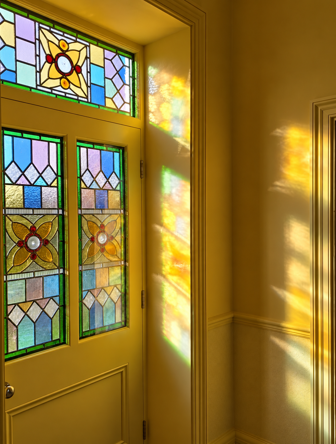 Sunlit ochre interior with stained glass.png