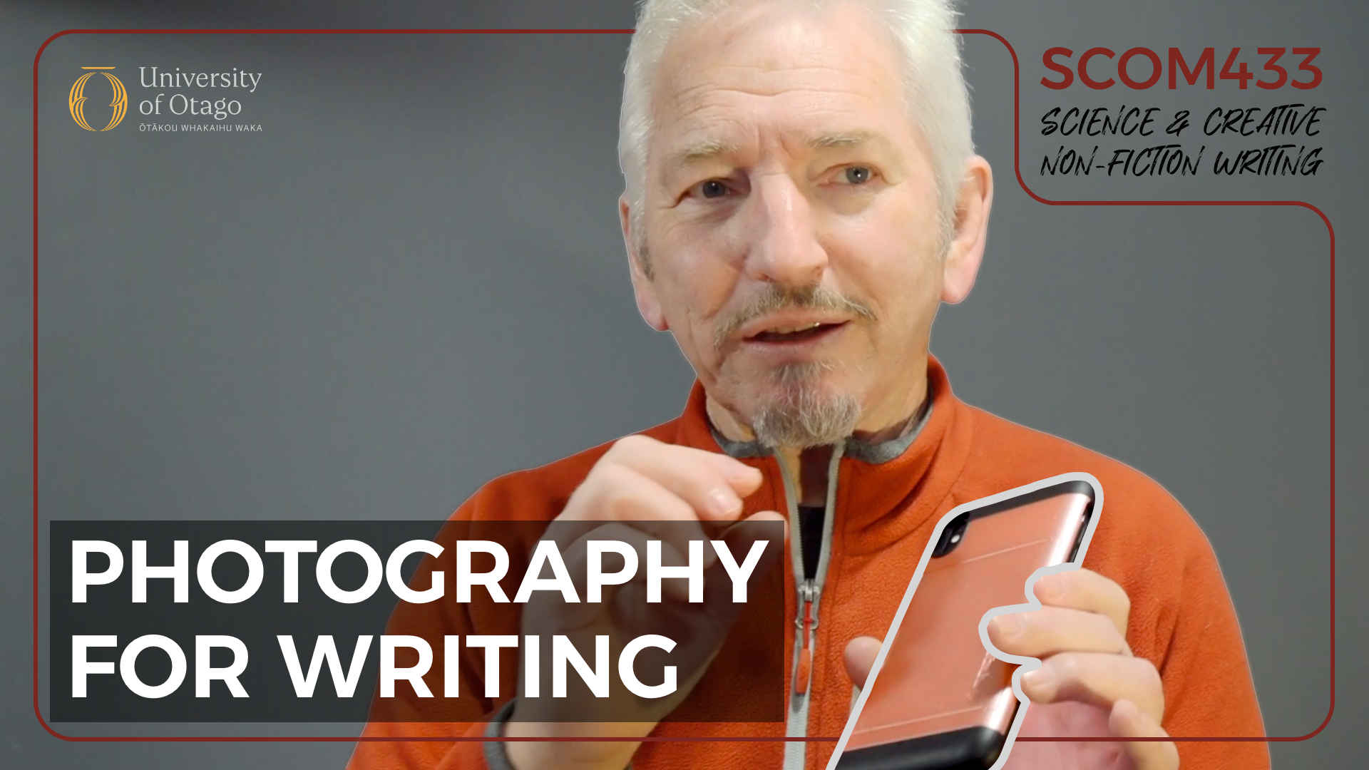 A man with gray hair and a beard, wearing an orange jacket, holds a smartphone in his hand and appears to be speaking or explaining something. The background is gray, and there is text and a logo in the top left corner reading 'University of Otago,' and there is additional text in the top right corner reading 'SCOM433 Science & Creative Non-Fiction Writing.' Large text at the bottom says 'Photography for Writing'.