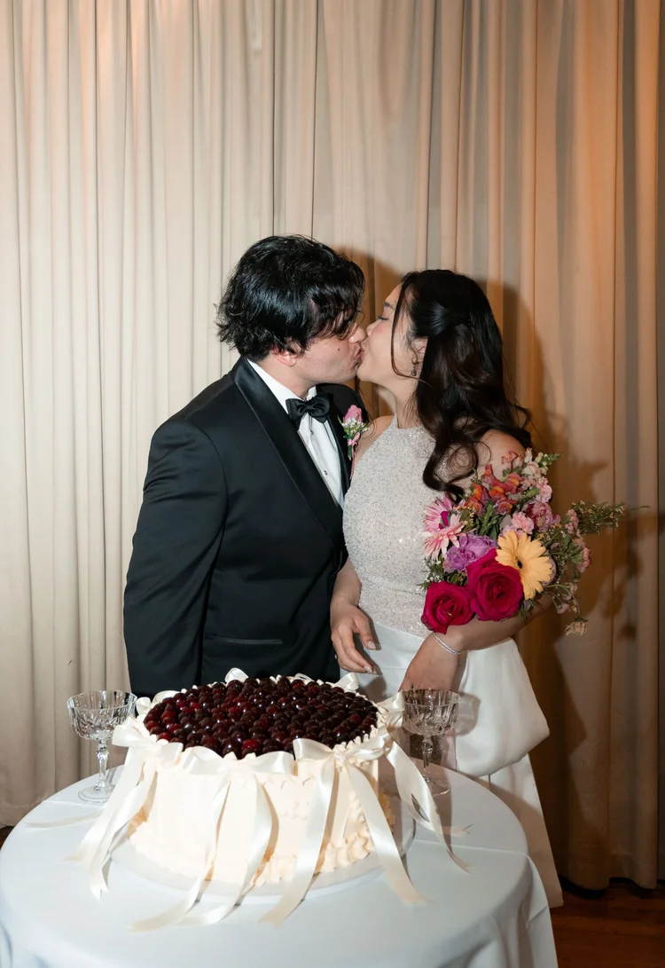 Carine and Michael sharing a sunset kiss at Rippon Lea Estate in Melbourne.
