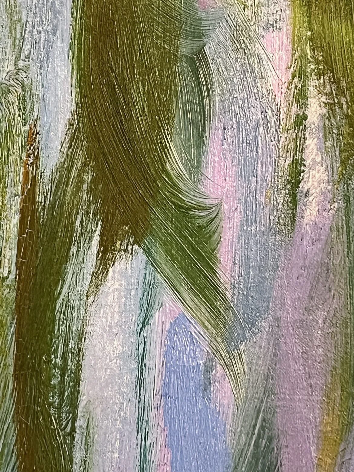 Close-up of a window with foggy glass streaked with green, pink, and blue paint or dye.