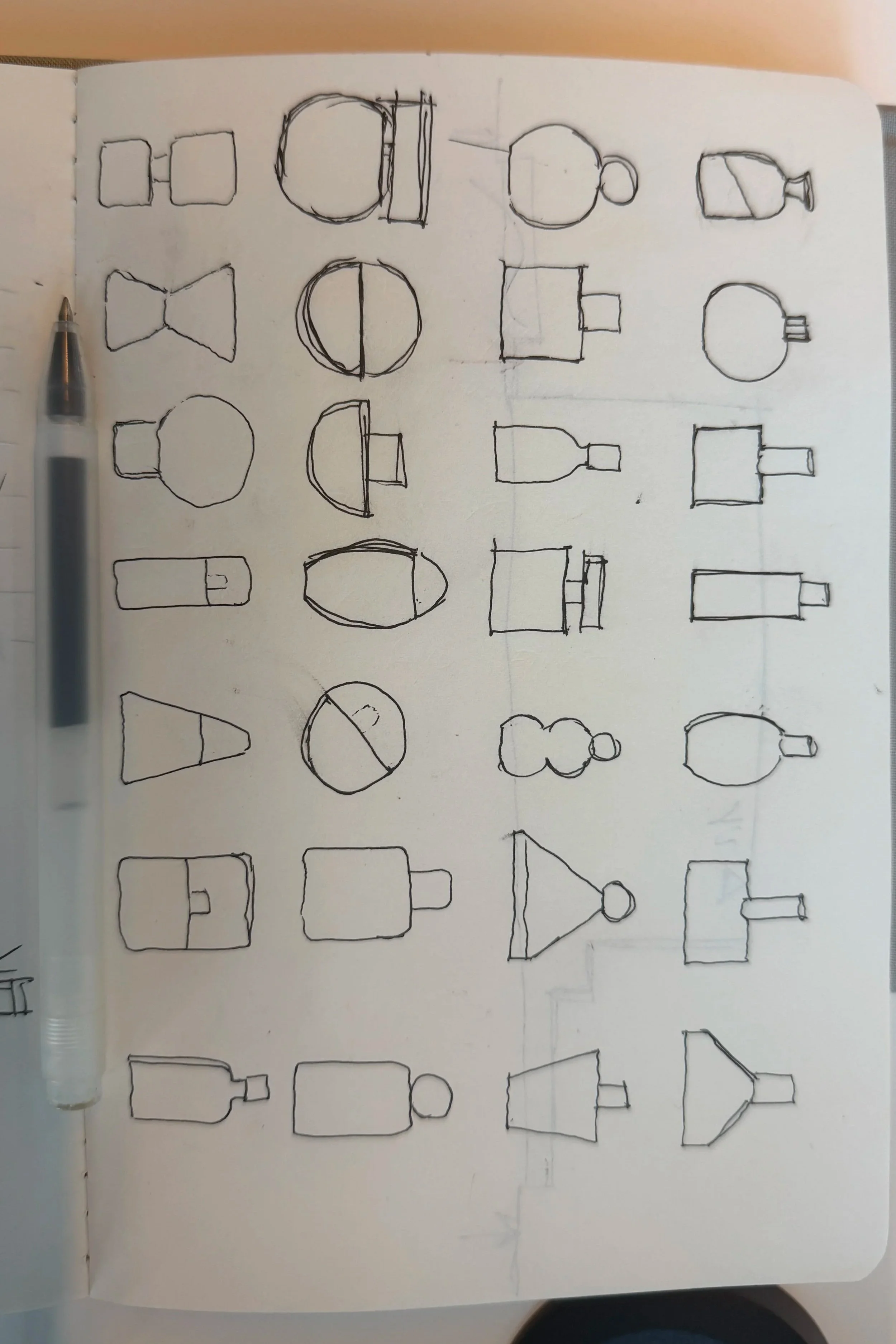 Sketches of various basic social media and communication icons, including a camera, chat bubbles, a megaphone, a globe, and a speech bubble, all drawn in black ink on a white paper.