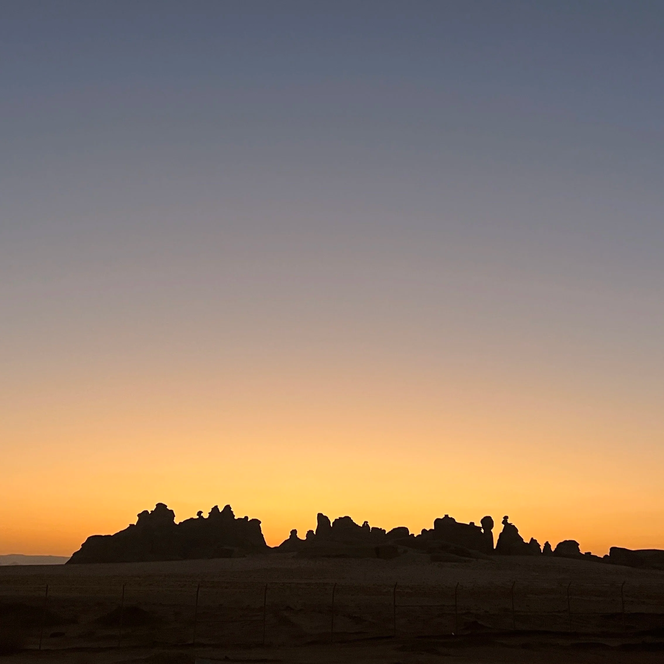 Silhouette of rocky landscape at sunset with colorful sky