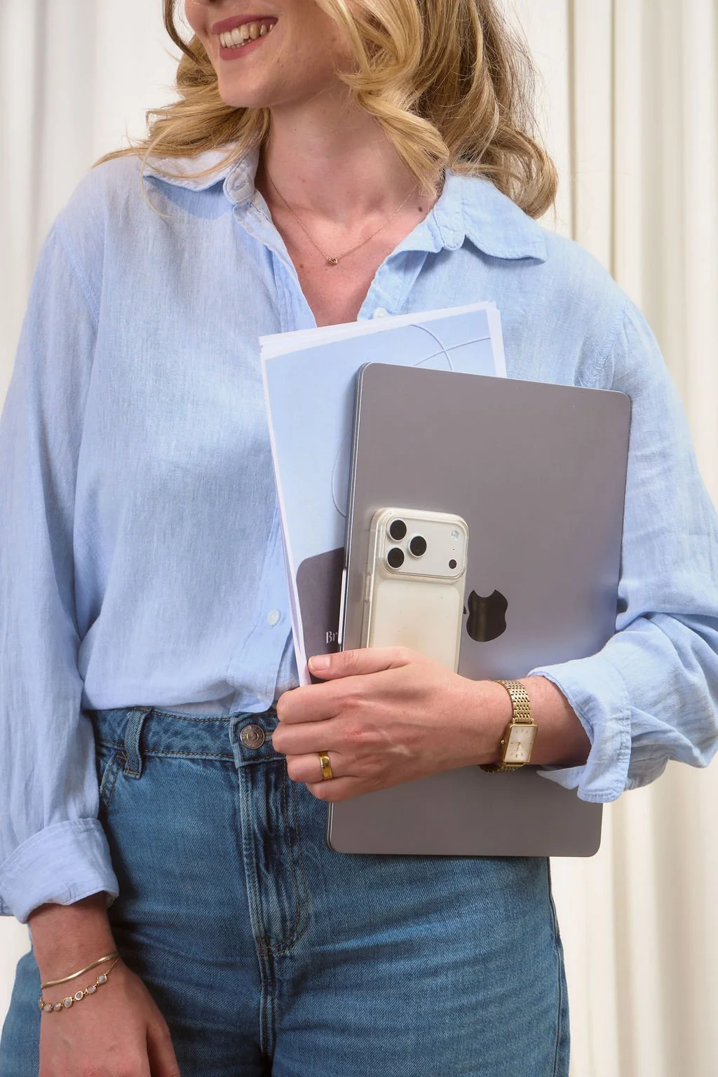 Emma J Maclachlan Marketing Consultant holding laptop and phone
