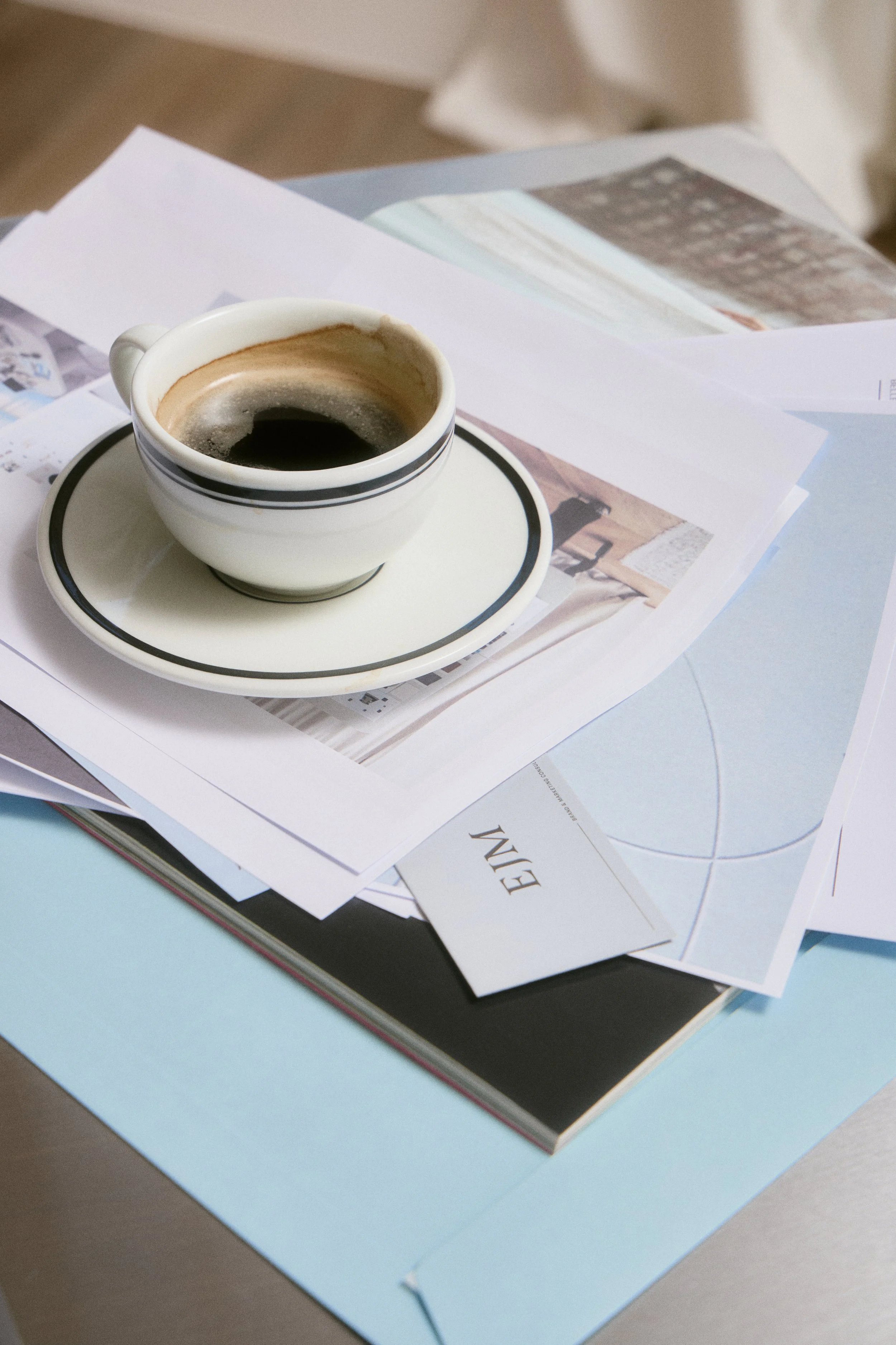 Flatlay for branding shoot with cup of coffee and documents