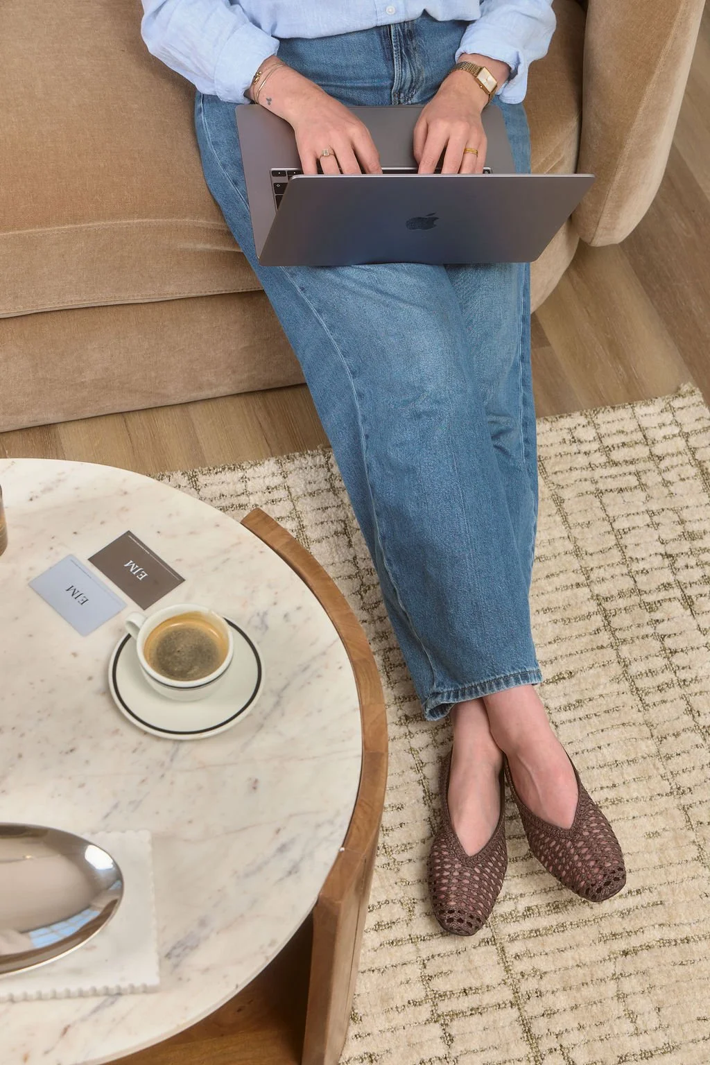 Emma J Maclachlan marketing consultant working on laptop with cup of coffee