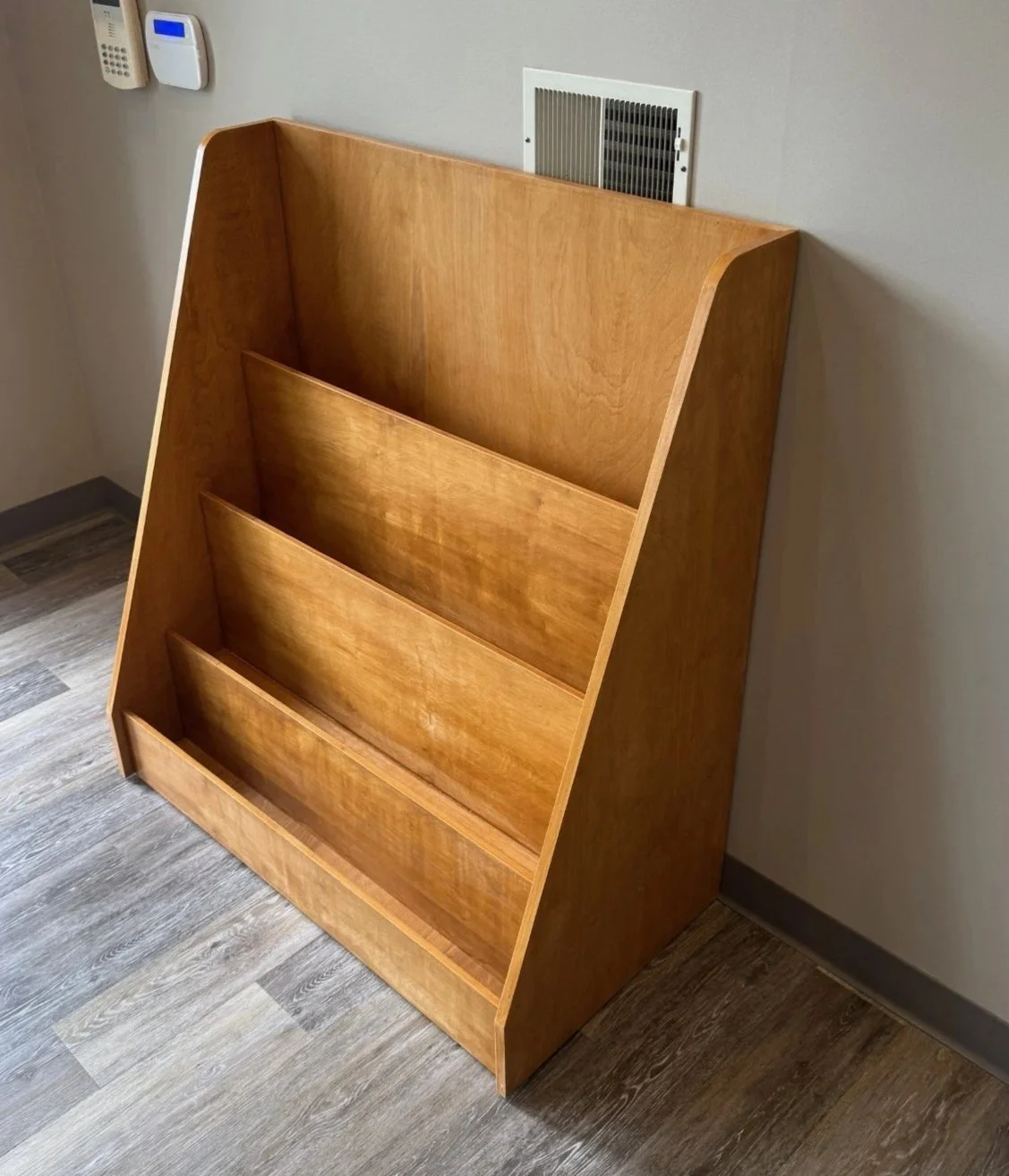 Custom standing wooden bookshelf.   