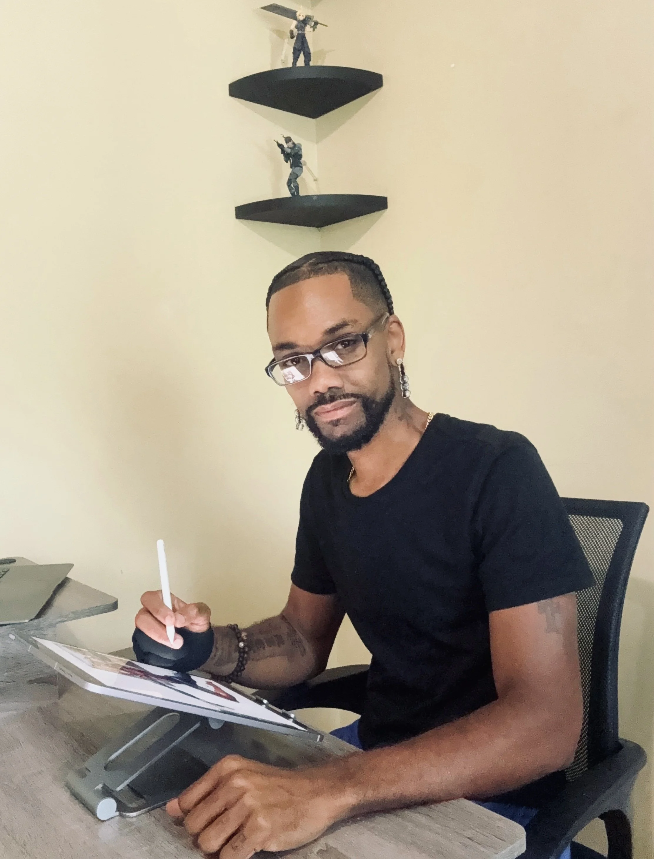 Riccardo Jaboin, creator, writer, and artist of W.A.R. (Weapons Against Righteousness), drawing digital comic artwork at his desk.