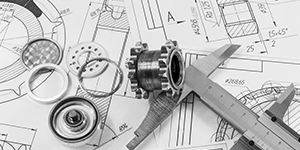 Mechanical engineering parts, including gears and bearings, on technical blueprints.