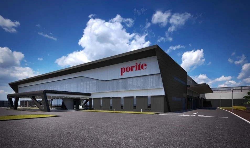A modern building with the word "porite" on it, under a partly cloudy blue sky.