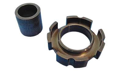 A metal bearing and a cylindrical roller on a black background.