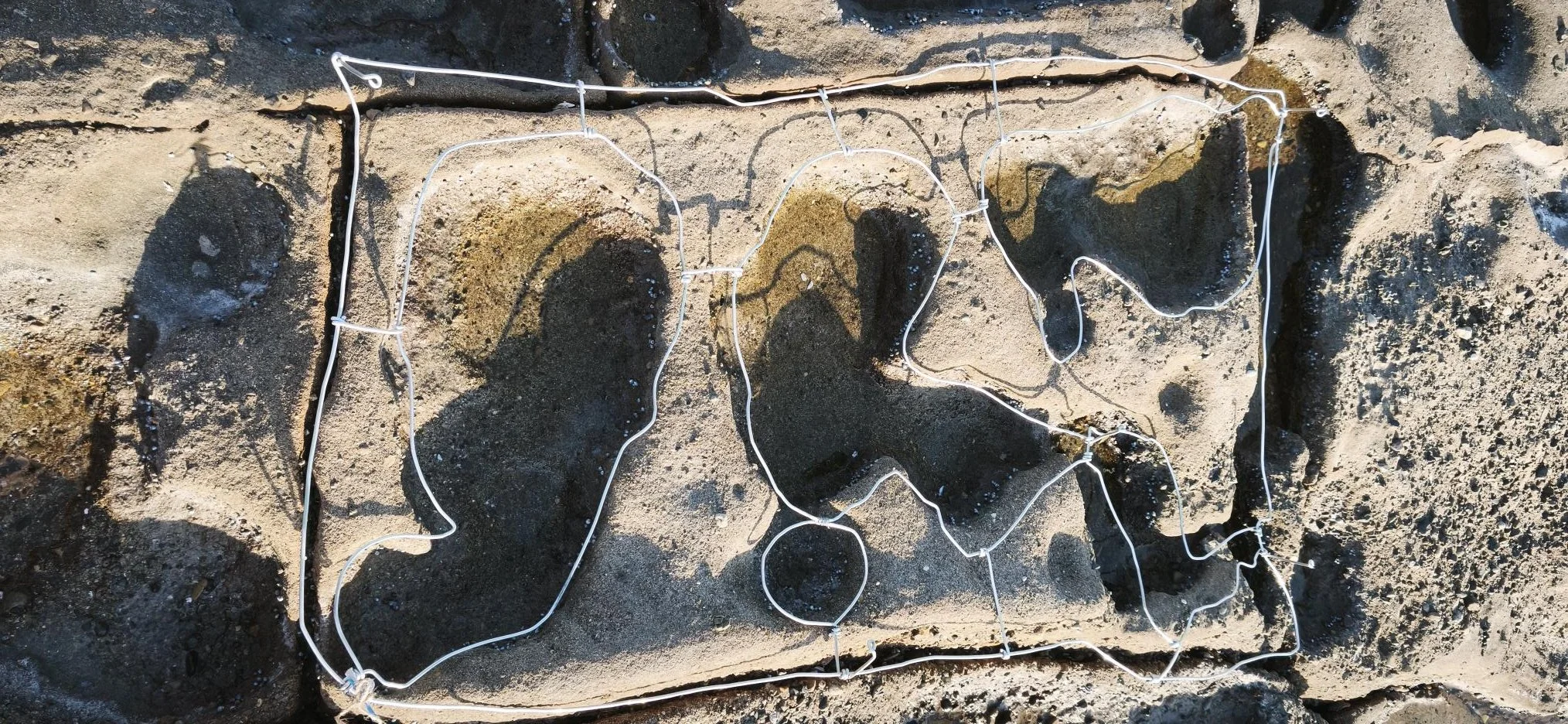 Sandstone bricks with a wire outline of the state of California placed on top.